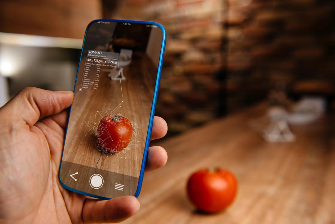 Man using augmented reality application on his phone for recognizing food.