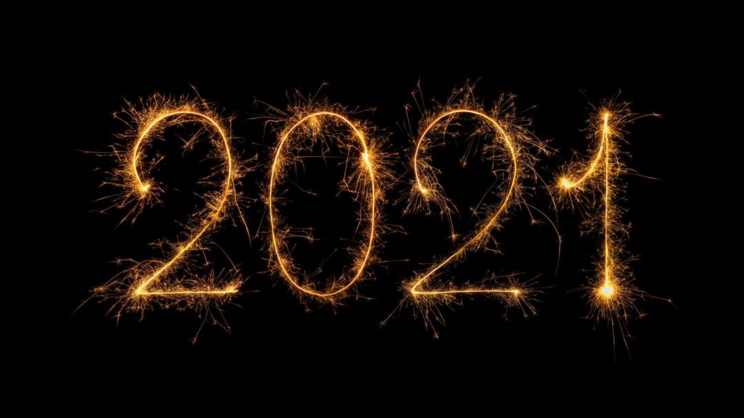 Happy New Year 2021 written with bengal fire, sparkler fireworks candle isolated on a black background.