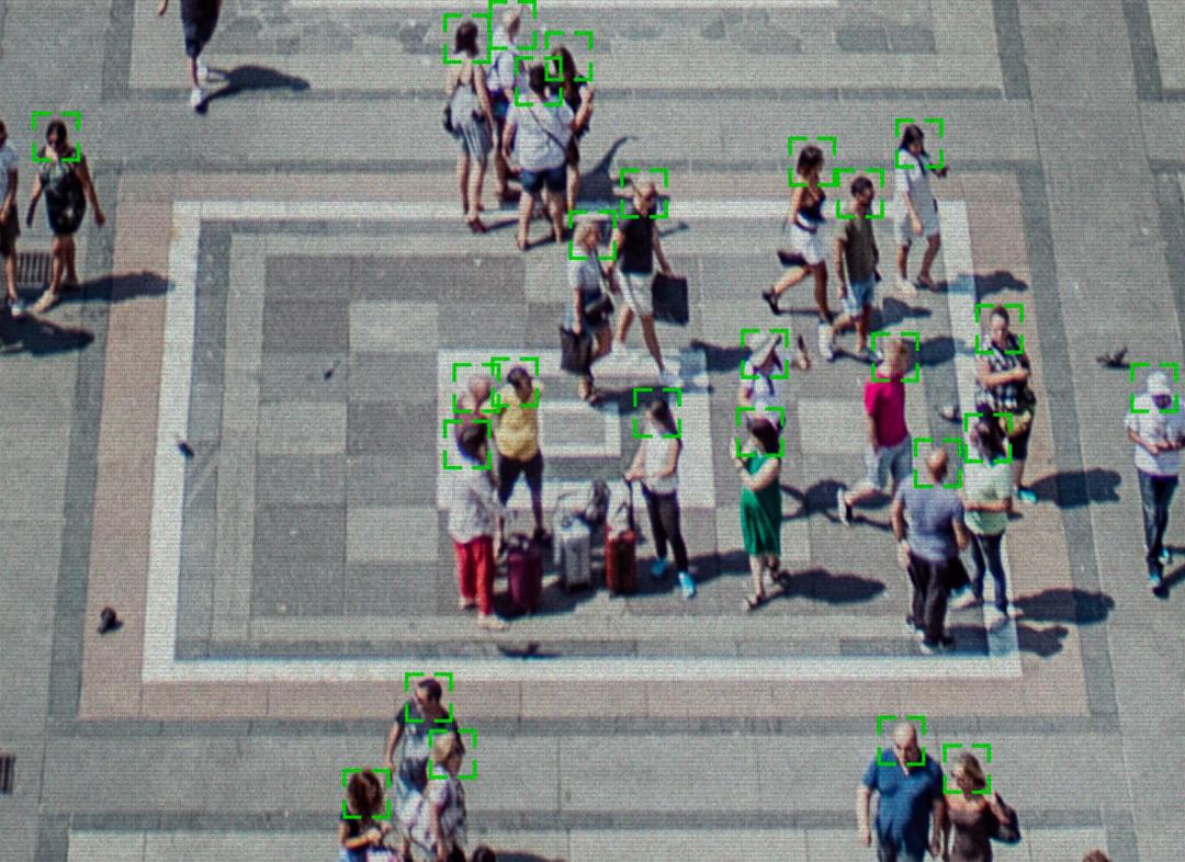 Illustration of camera scanning faces in public square