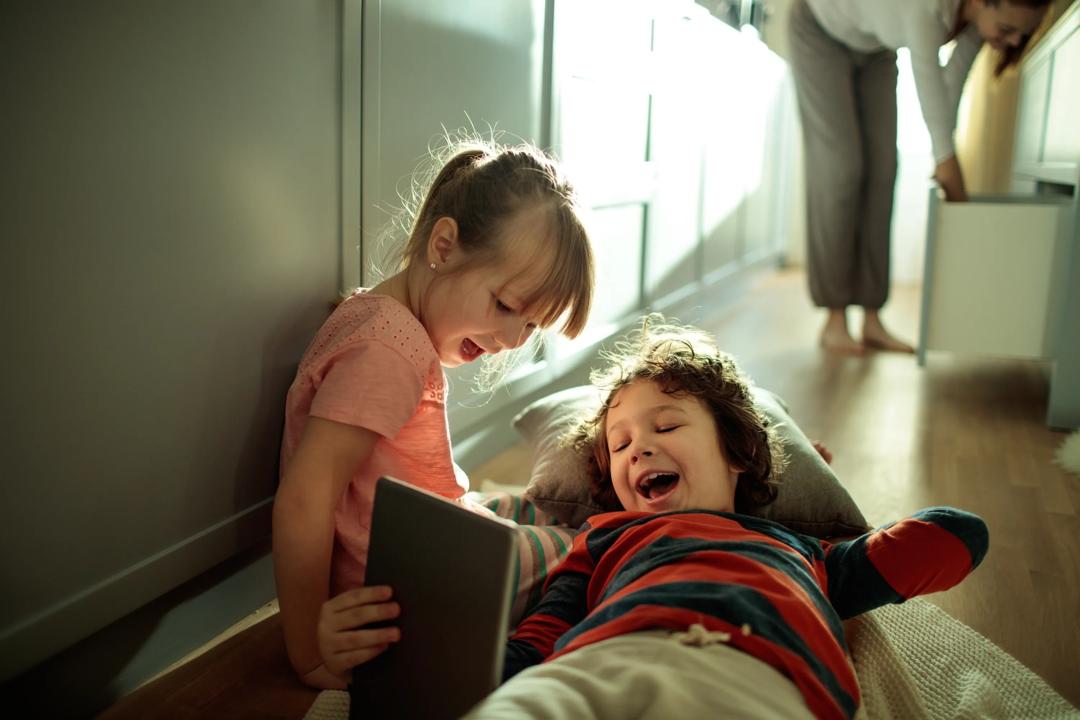 Our everyday lives is becoming more and more digitised (kids on tablet pictured). 