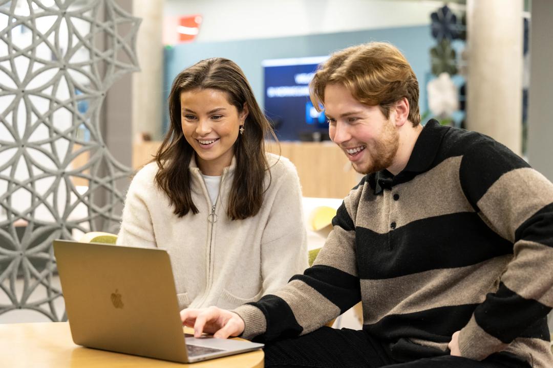 Two students looking at a PC