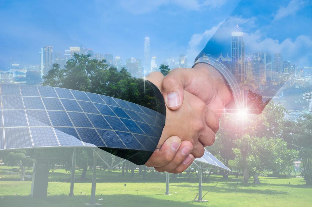 Double Exposure of a businessman handshake on the background blurred downtown nightlife. Concept of an agreement green energy.