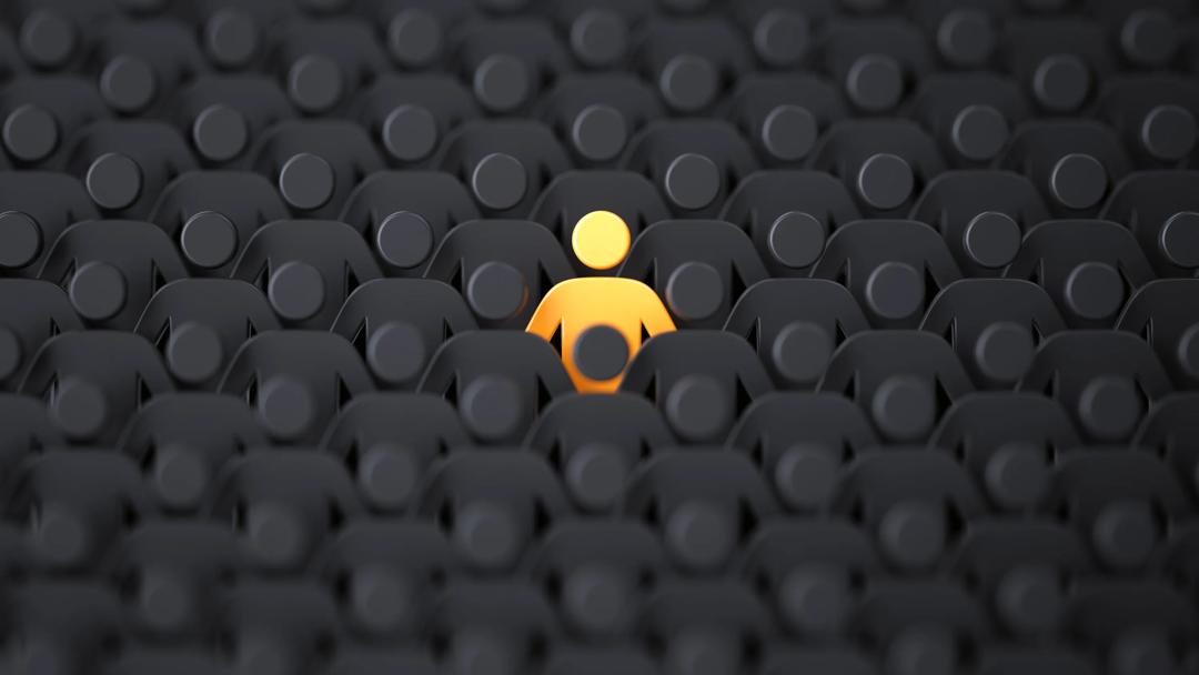 Unique color yellow human shape among dark ones. Leadership, individuality and standing out of crowd concept