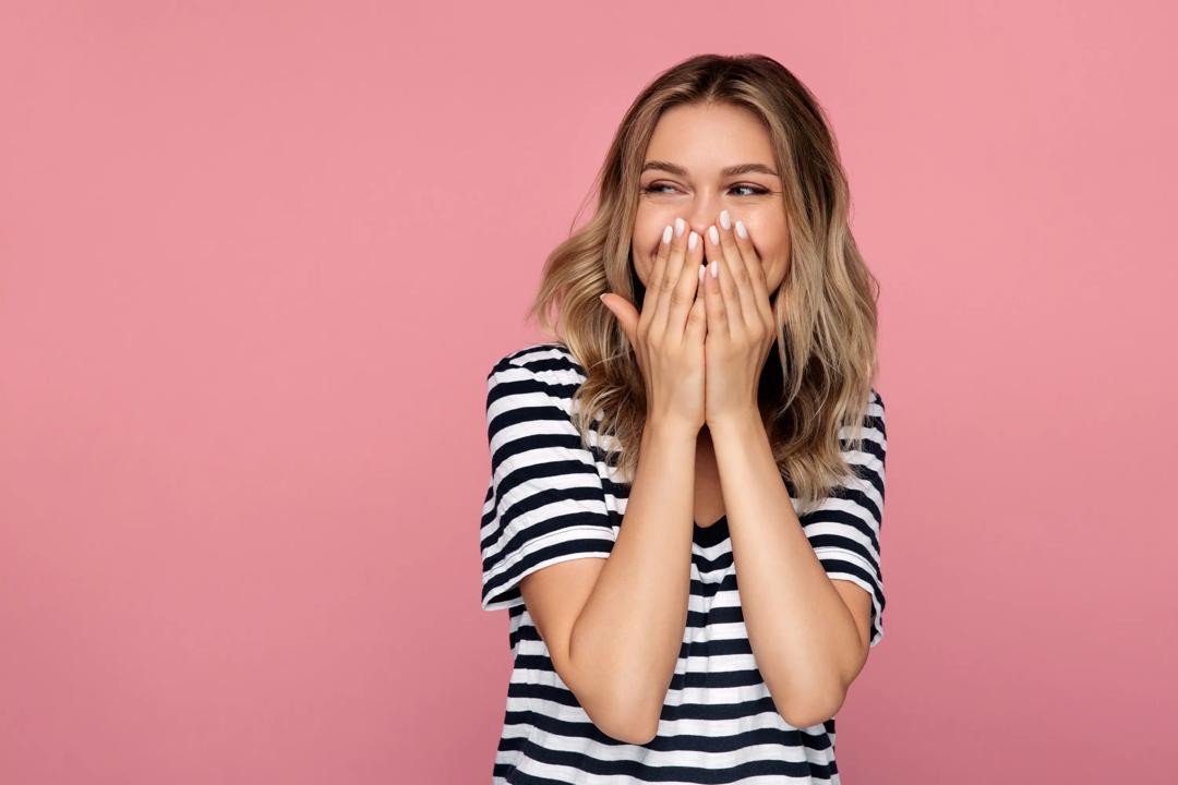 Laughing girl on pink background