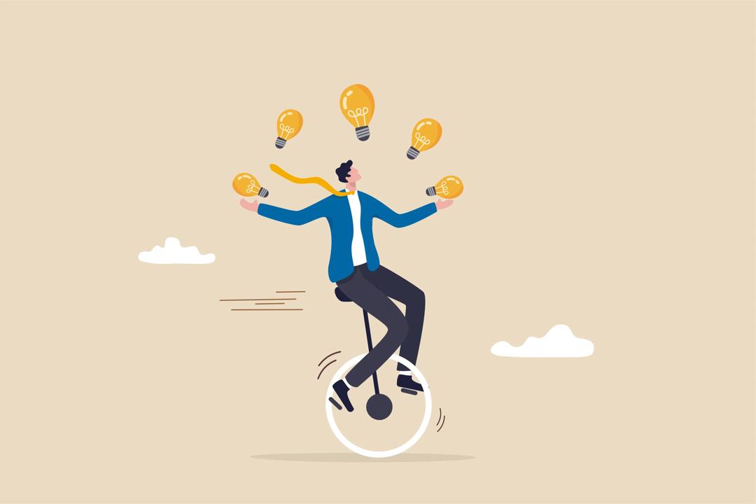 Businessman riding unicycle juggling lightbulbs.