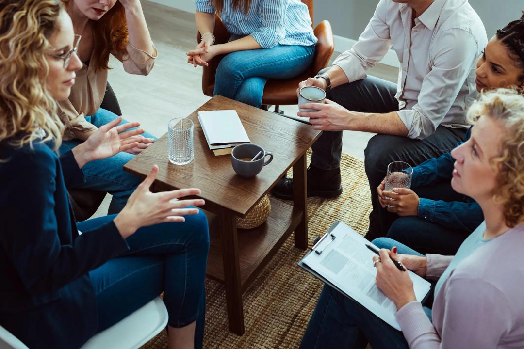 People sitting around a table and discussing