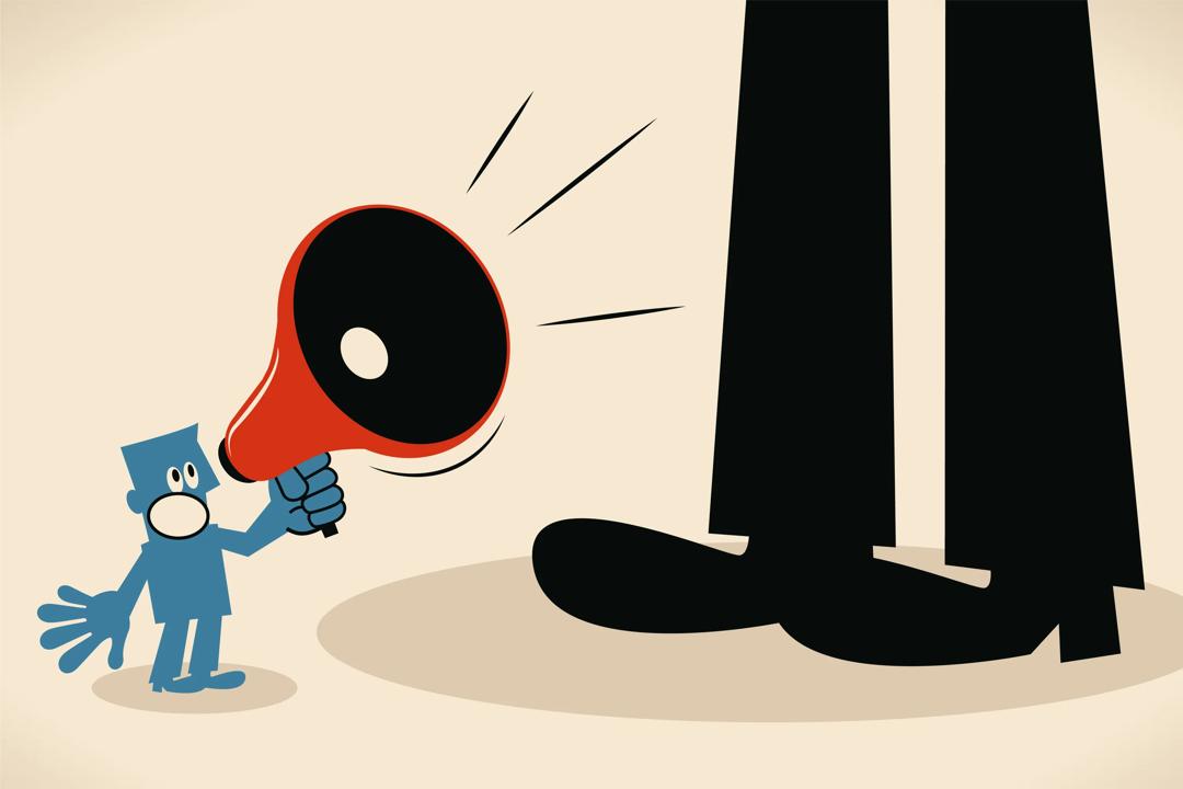 Illustration of small man with microphone shouting a giant black figure