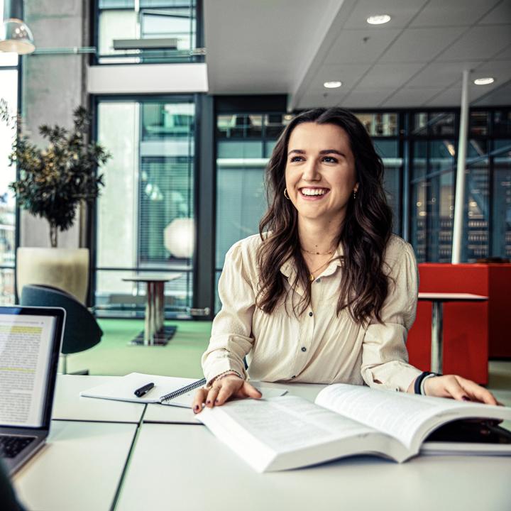 A woman smiling sitting in a building