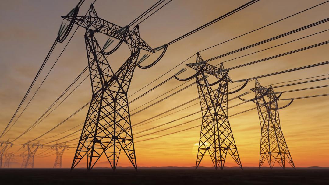 Power lines against setting sun