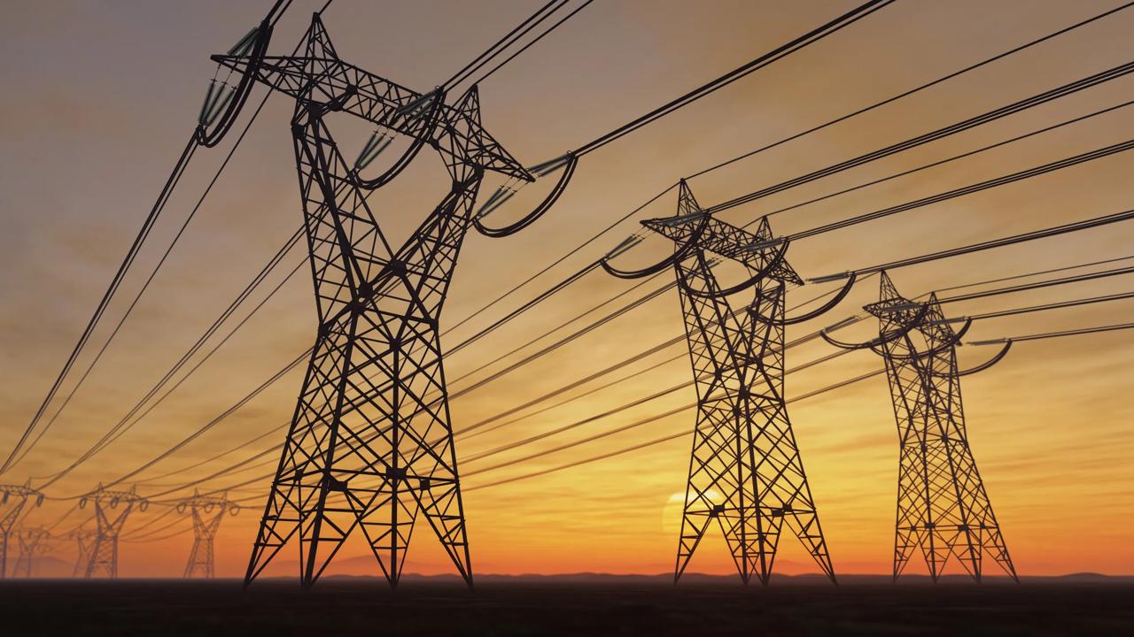 Power lines against setting sun
